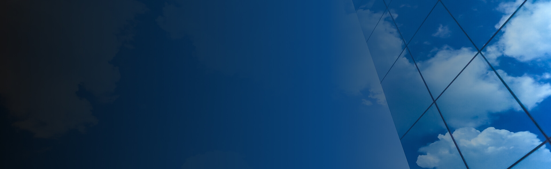 Blue sky with clouds reflection on a glass pane