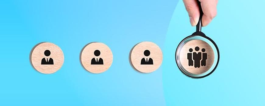 A group of round wooden circles with black people icons
