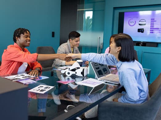 a group of people shaking hands after post-workshop engagement session